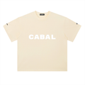 A apricot-colored short-sleeve t-shirt with 'CABAL' printed in bold white letters across the chest, displayed flat against a white background.